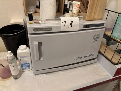 a toaster sitting on top of a counter next to a trash can
