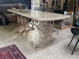 a table and chairs in a room with a rug on the floor