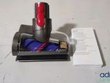 a red corded vacuum that is sitting on a table