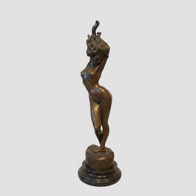 an image of a bronze statue of a woman with a bird on her head