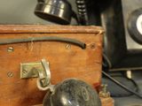 a wooden box with a telephone on top of it