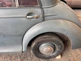 an old car that is parked on the side of the road