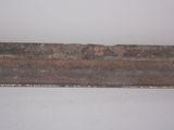 a rusted piece of wood on the wall of a room