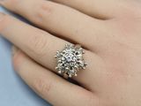 an image of a woman ' s hand with a diamond ring on it