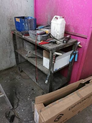 a box of water sitting on the floor next to a table