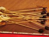 five spoons that are sitting on top of a table