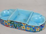 a small blue tray with a flower design on it