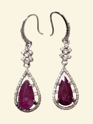 a pair of ruby and diamond earrings on a white background