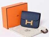 an image of a blue purse with a gold h on it
