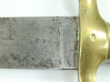 a close up of a knife on a white surface