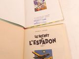 two books that are open on a white surface