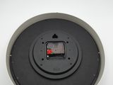 a close up of a black and red button on a white surface
