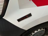 a close up of a clock on the back of a car