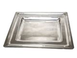 a close up of a metal tray on a white background