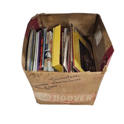 a cardboard box full of books on a white background