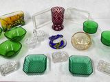 many green glass items sitting on a white table