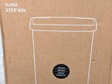 cardboard box with a picture of a trash can inside of it