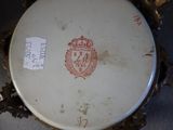 a white plate with a red crest on it