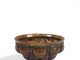 a brown bowl sitting on top of a white table