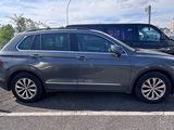 the grey car is parked in the parking lot next to other cars