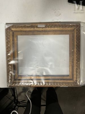 a picture frame that is wrapped in plastic and sitting on a chair