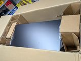 a box with a laptop inside of it on the floor