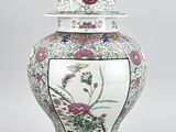 an image of a vase with a lid and flowers on it