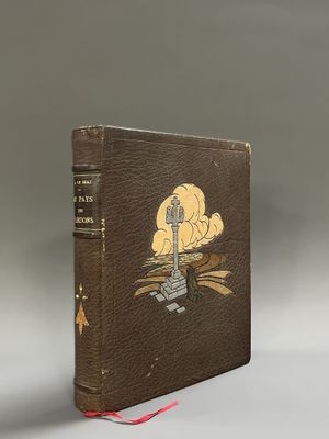 un vieux livre posé sur une table, à côté d'un ruban rouge