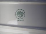 a close up of a white oven with a green logo on it