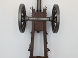 a small wooden cannon mounted on a wall
