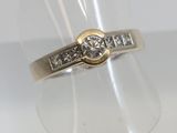 an image of a diamond ring on a clear ring holder
