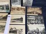 several old black and white photographs of people and vehicles on a table