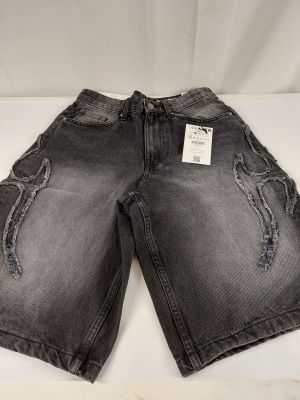 a close up of a pair of black denim shorts on a white background