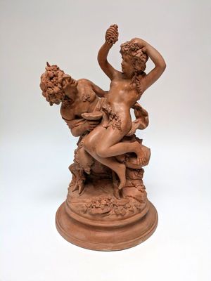 statue of a woman and a man sitting on a rock