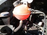an orange ball sitting on top of the engine of a car