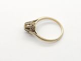 a close up of a gold ring on a white surface
