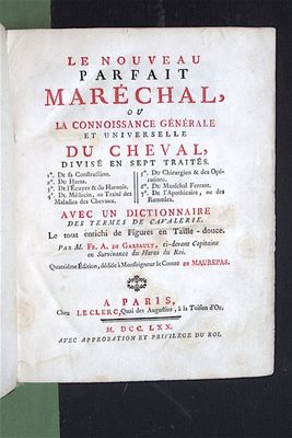an old book with a black cover and red writing on it
