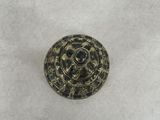 a close up of a metal button on a white surface