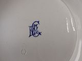 a white plate with a blue and white design on it