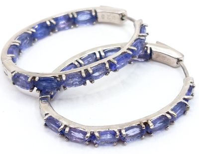 pair of tanzanite hoop earrings on a white background