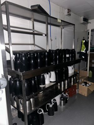 many cups and mugs on the shelves in the room