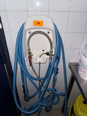 a white toilet with a blue hose attached to it