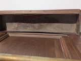 a wooden box with a metal handle on top of a table