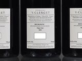three bottles of wine sitting on top of a table next to each other