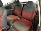 two seats in the back of a car that are red and grey