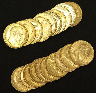 a close up of a pile of gold coins on a black surface