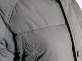 the back of a woman ' s jacket with a hood and zippers