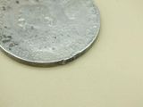 a silver coin sitting on top of a table