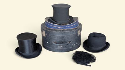 three hats and a top hat on top of a box