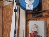 a picture of a blue hose is hanging on a wall